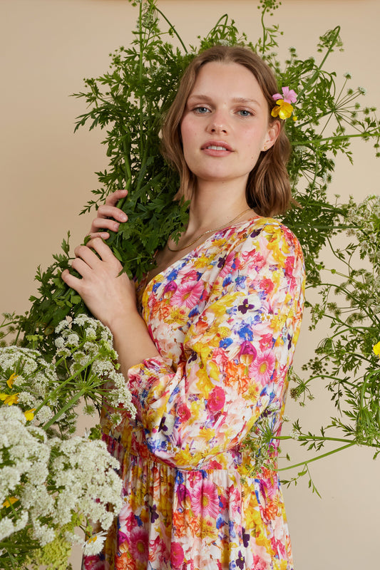 Multicolour floral midi dress with long sleeves, V-neckline, gathered waist, and lightweight flowing fabric.