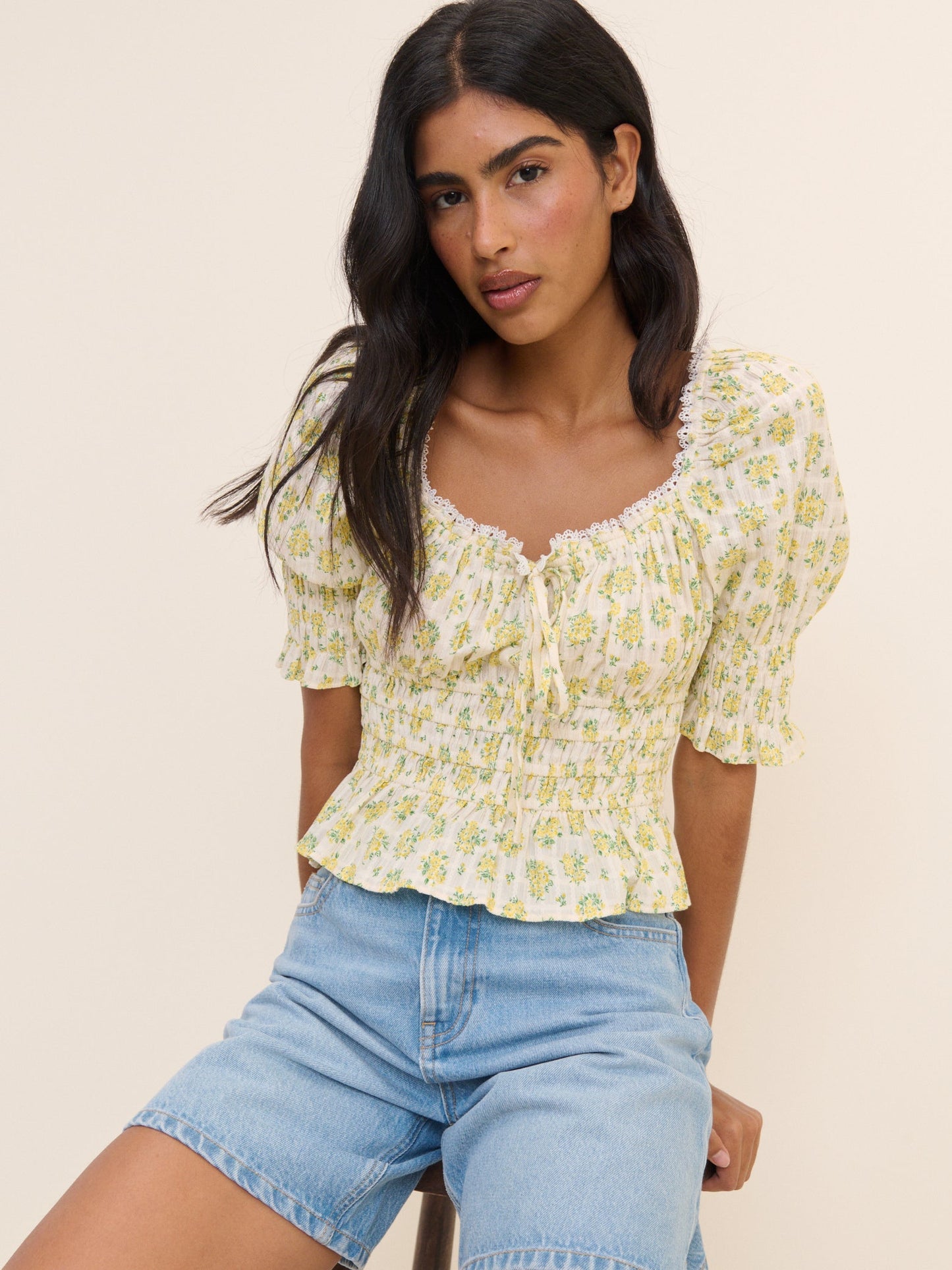 Floral shirred yellow and white drawstring blouse.