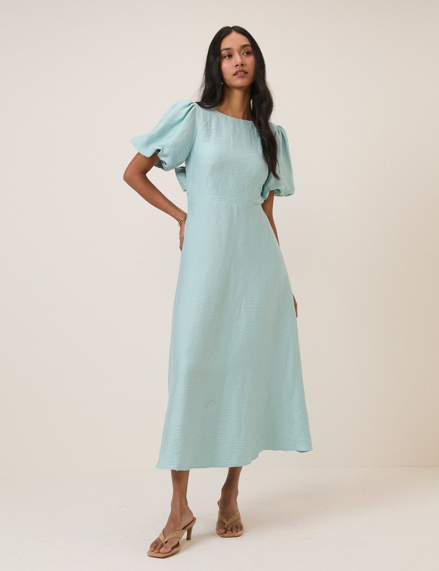 Light blue round neck puff sleeve midi dress with bow tie back.