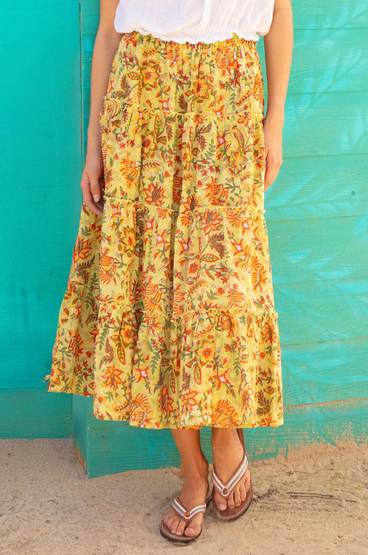 Yellow floral tiered midi skirt with elastic waistband and orange and green botanical print.