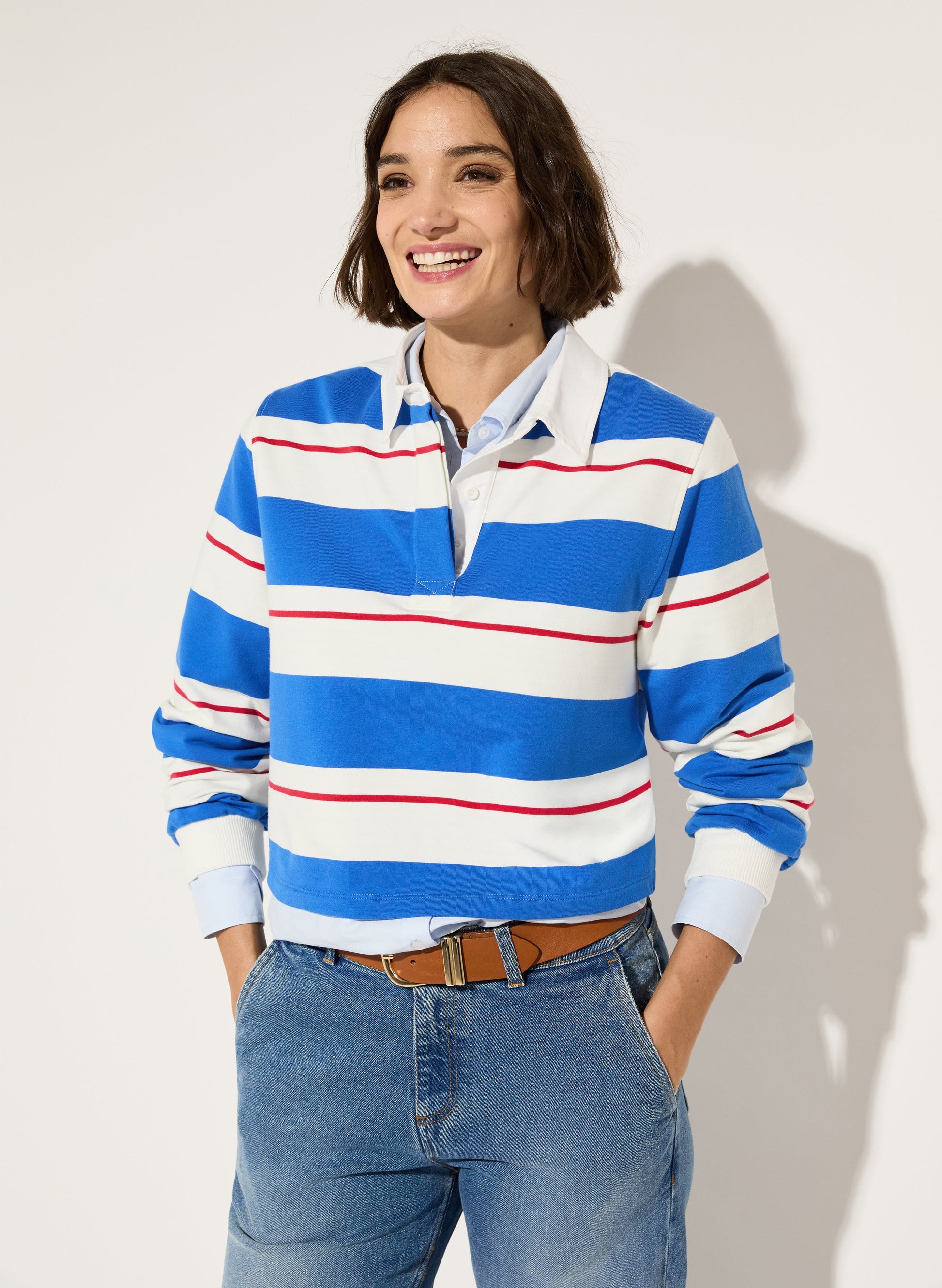 Bright blue, white and red striped rugby top.