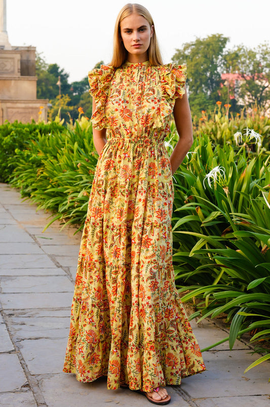 Yellow floral maxi dress with high neckline, ruffled cap sleeves, elastic waist, and orange and green botanical print.