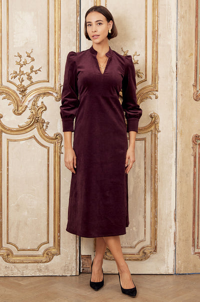 Burgundy corduroy midi dress with puff shoulders.