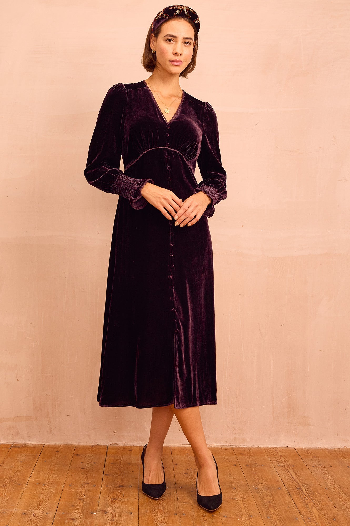 Deep burgundy velvet v-neck midi dress with flared cuffs.