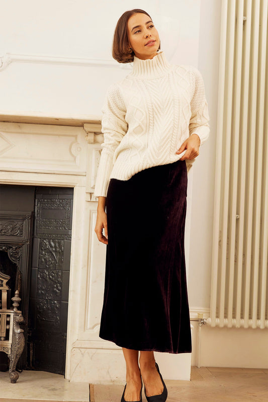 Deep plum velvet midi skirt with straight silhouette, fitted waistband, and mid-calf length.