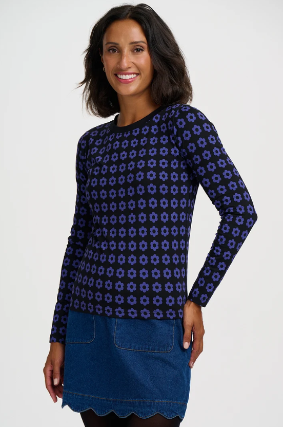 Black long-sleeve top with blue geometric floral print.