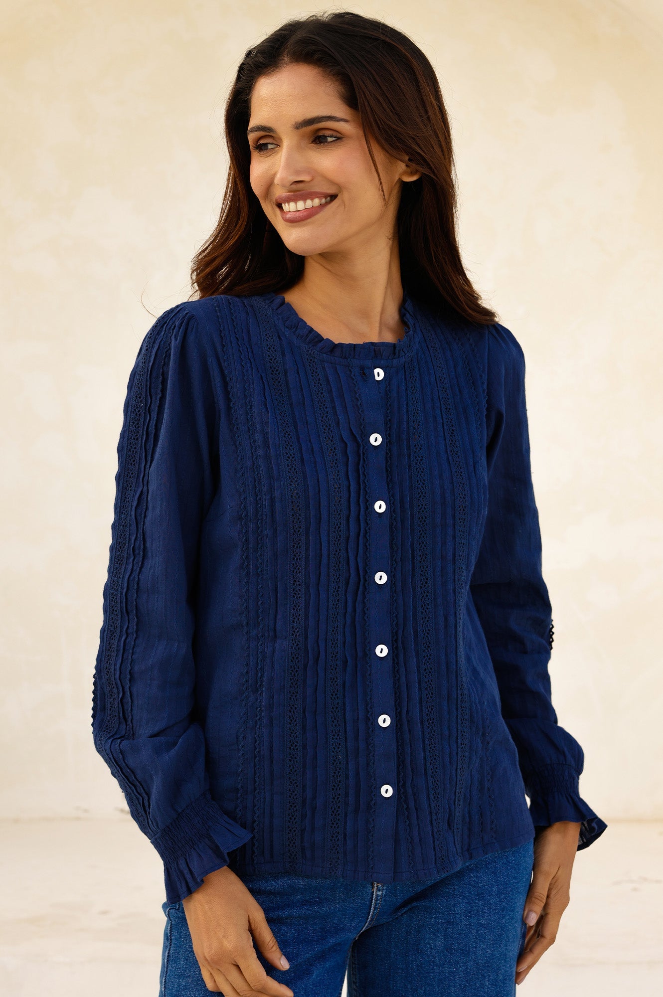 Navy lace blouse with pintuck detailing, ruffle neckline, button front, and long sleeves