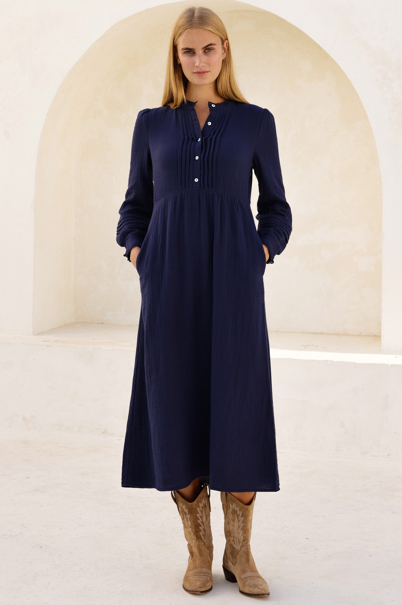 Deep navy midi dress with button placket, long sleeves, and gathered waist.