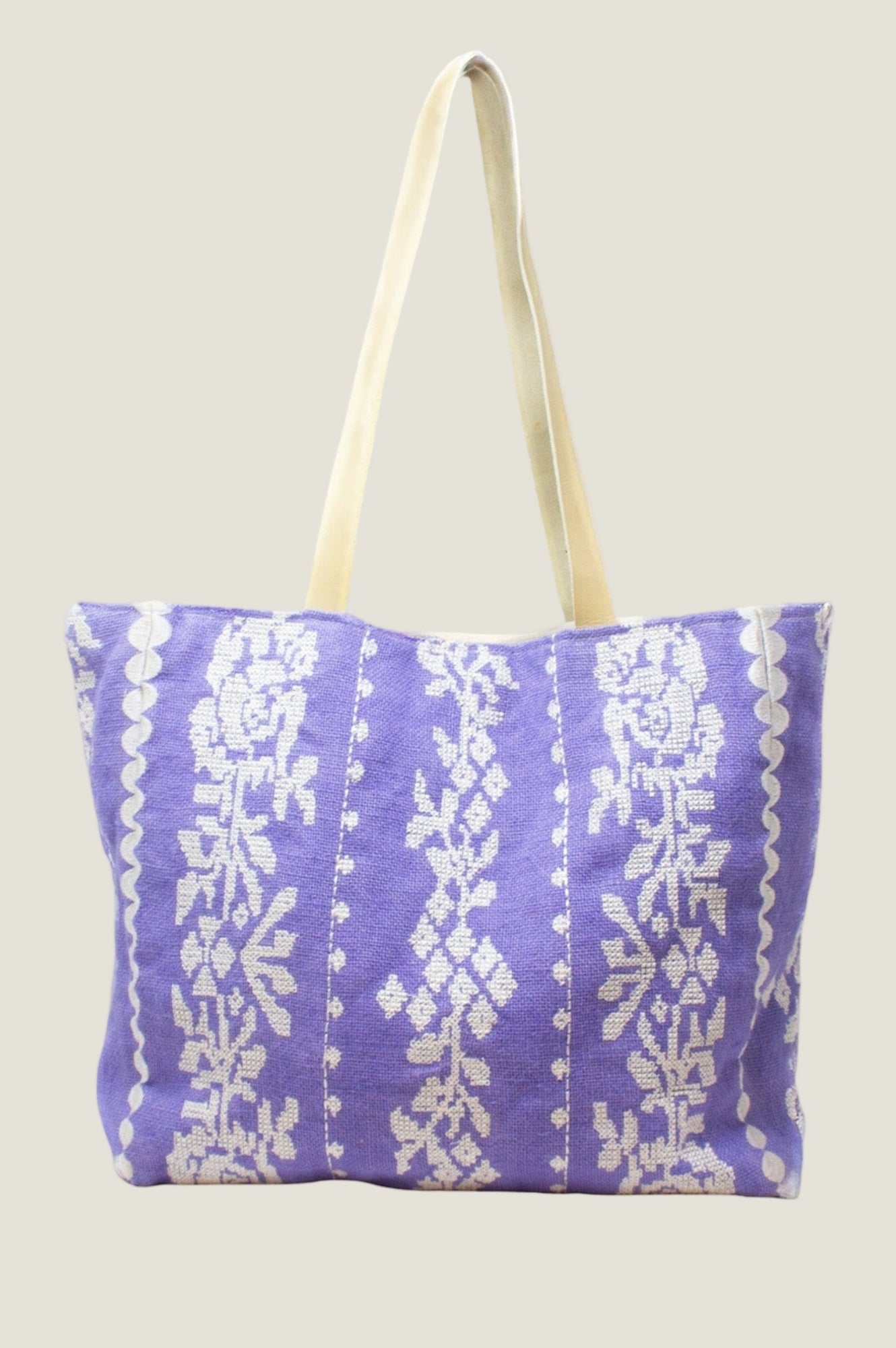 Lavender and white jute tote bag with floral stripe pattern and long shoulder straps.