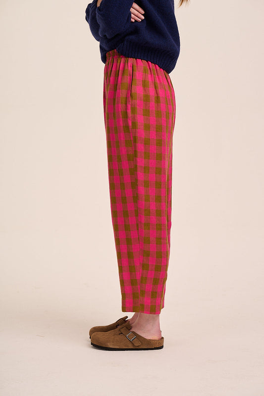 Pink and brown check trousers with elasticated waist, straight leg silhouette, and lightweight woven fabric.