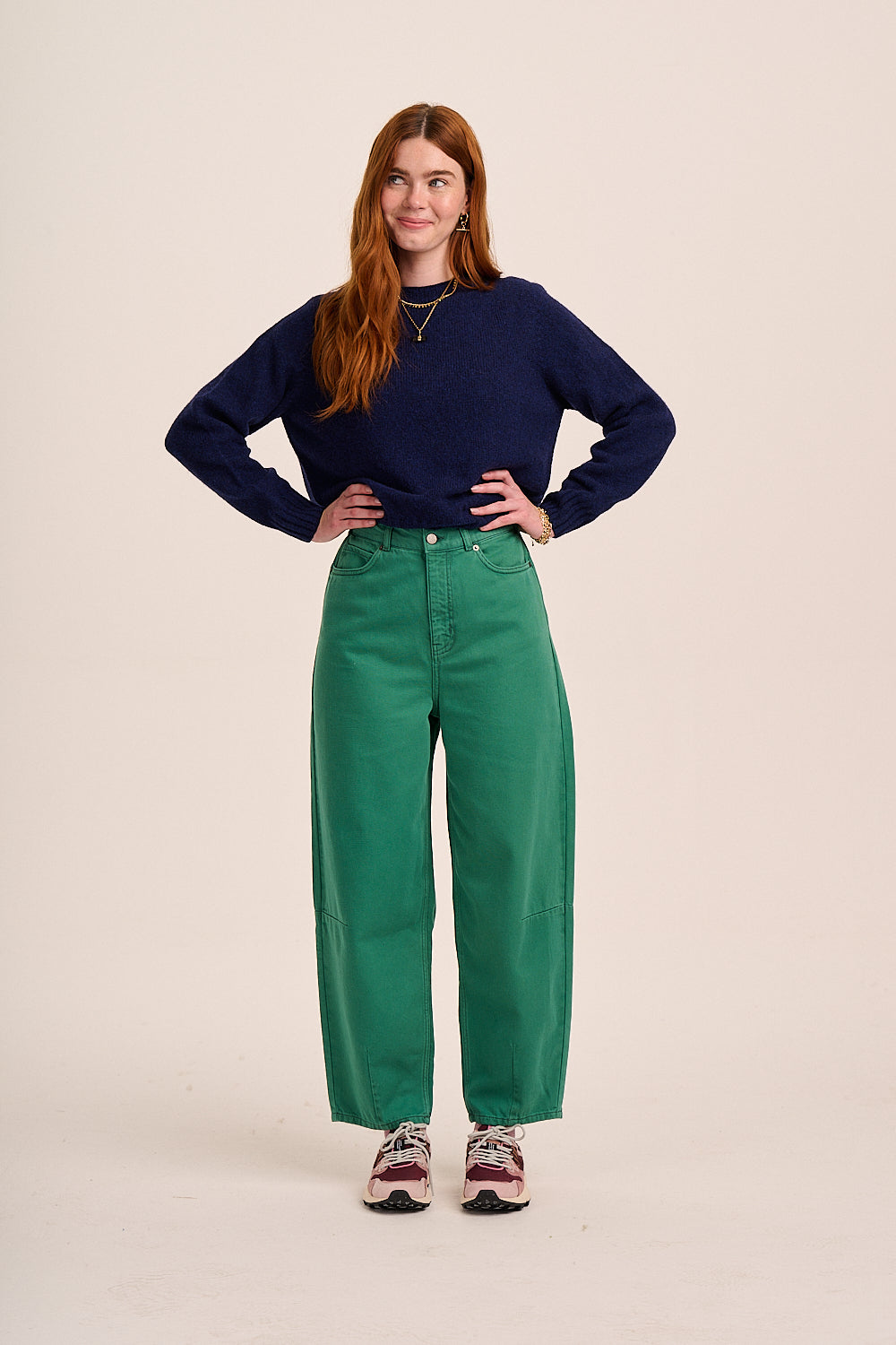 Green denim jeans with high-rise waist, wide leg silhouette, front button fastening, and structured cotton fabric.