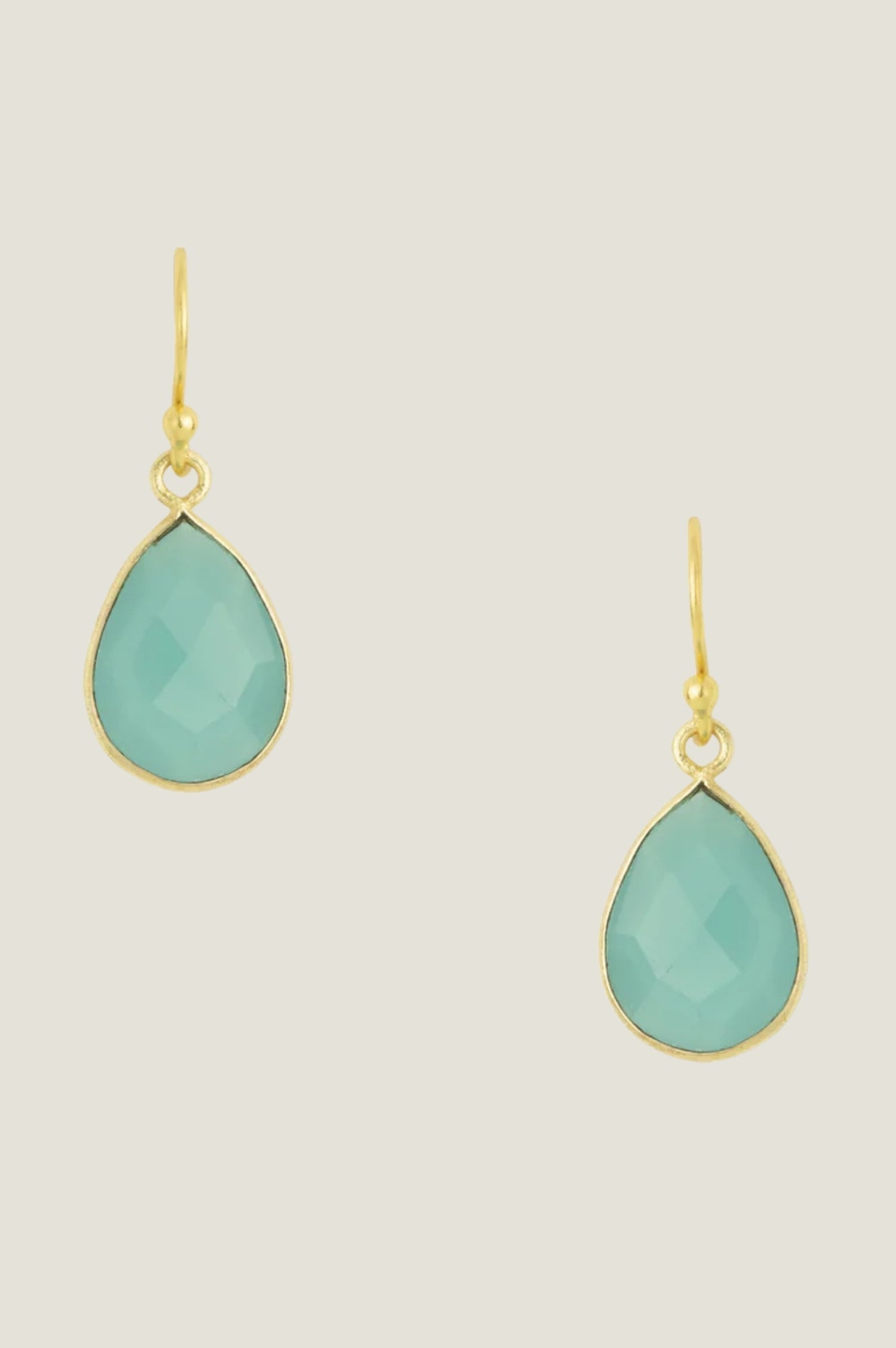 Gold teardrop earrings with aqua gemstones.