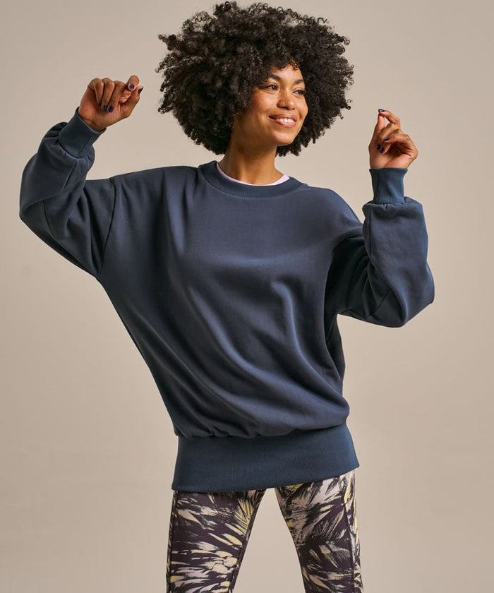 Soft navy longline sweater with pleated back.