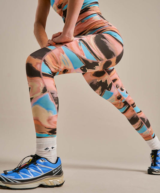 Coral, peach, brown, and turquoise abstract print activewear leggings.