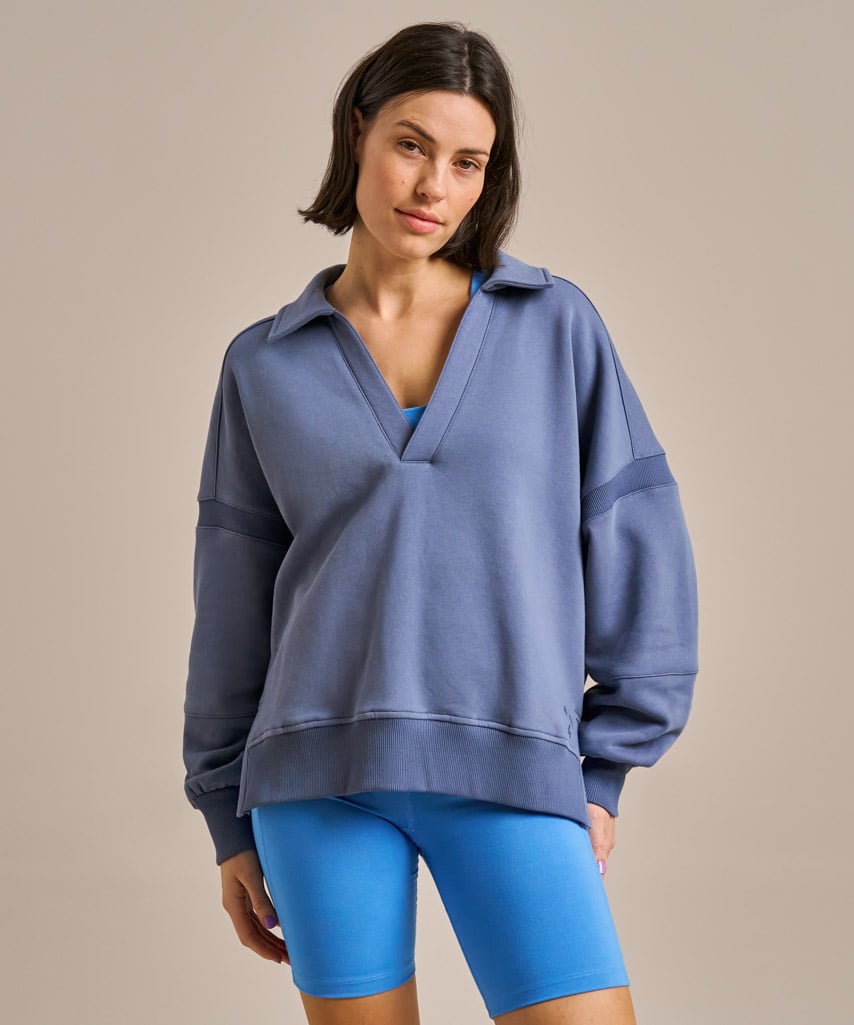 Soft mid-blue organic cotton collared v-neck sweatshirt.