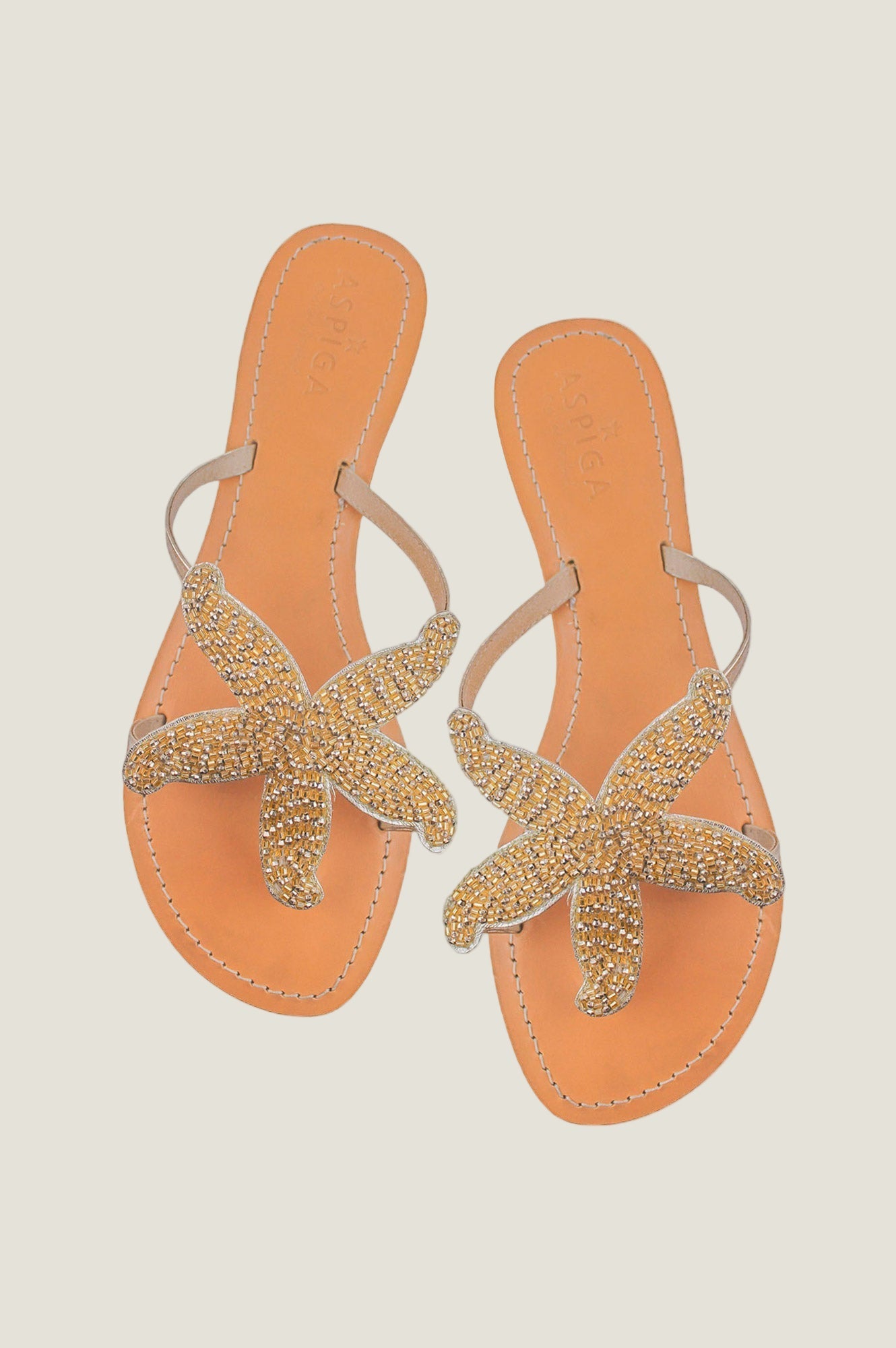 Gold beaded starfish sandals with toe post, slim straps, and flat sole.