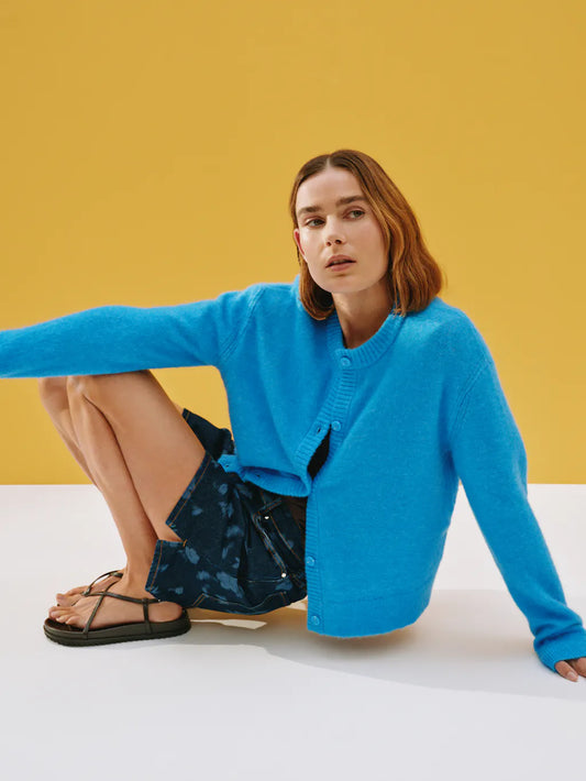 Bright blue round neck cardigan.