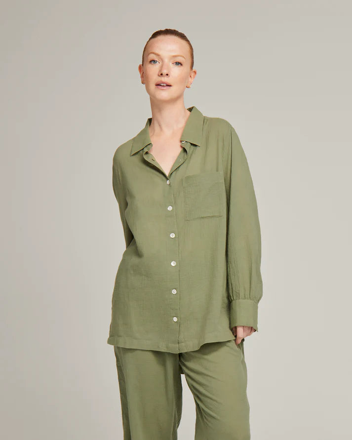 Model wearing an olive green 100% organic cotton midi shirt pyjama set by Nudea, filtered for the Warm Spring, Warm Autumn, and Soft Autumn colour seasons by Shop My Palette.