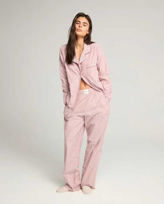 Woman wearing mulberry and cream stripe BCI cotton pyjama set from Nudea, filtered for the Light Spring and Light Summer colour seasons by Shop My Palette.