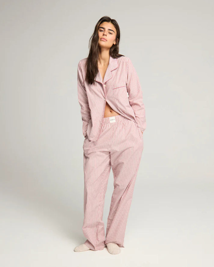 Woman wearing mulberry and cream stripe BCI cotton pyjama set from Nudea, filtered for the Light Spring and Light Summer colour seasons by Shop My Palette.