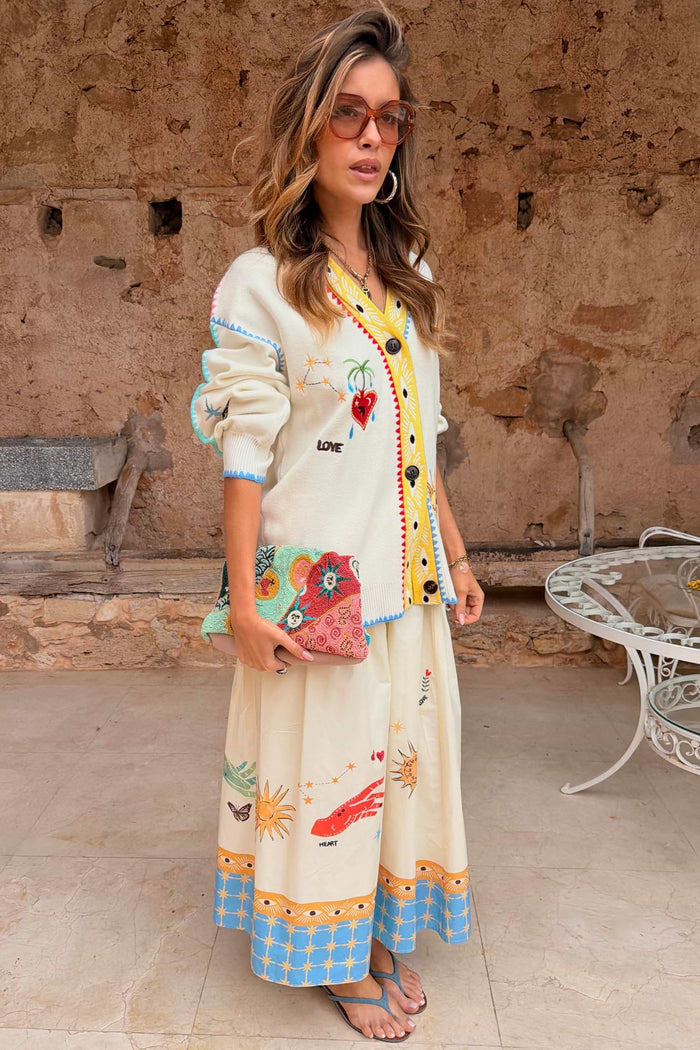 Cream cardigan with yellow and turquoise accents.