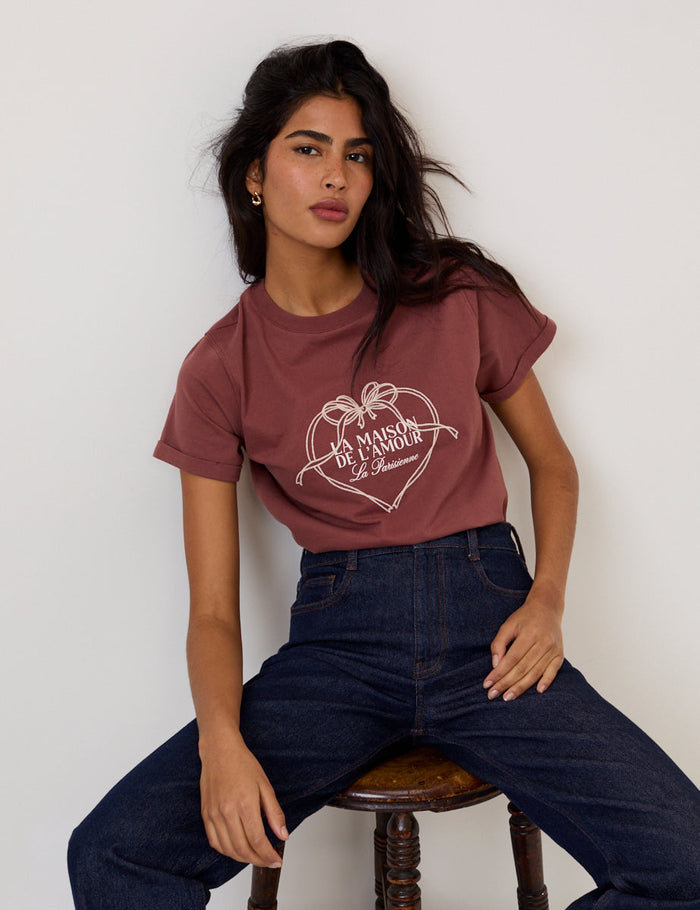Soft brown t-shirt with "La Maison de l'Amour" graphic text in a heart.