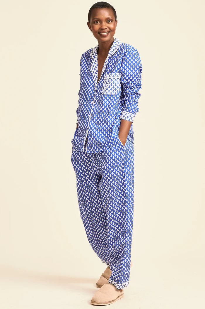 Woman wearing an organic cotton high contrast blue and white patterned pyjama set by Aspiga, shown in a Clear Winter and Cool Winter colour season palette, filtered by Shop My Palette.