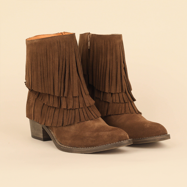 A pair of brown suede fringe ankle boots with low block heels, shown on a plain beige background.