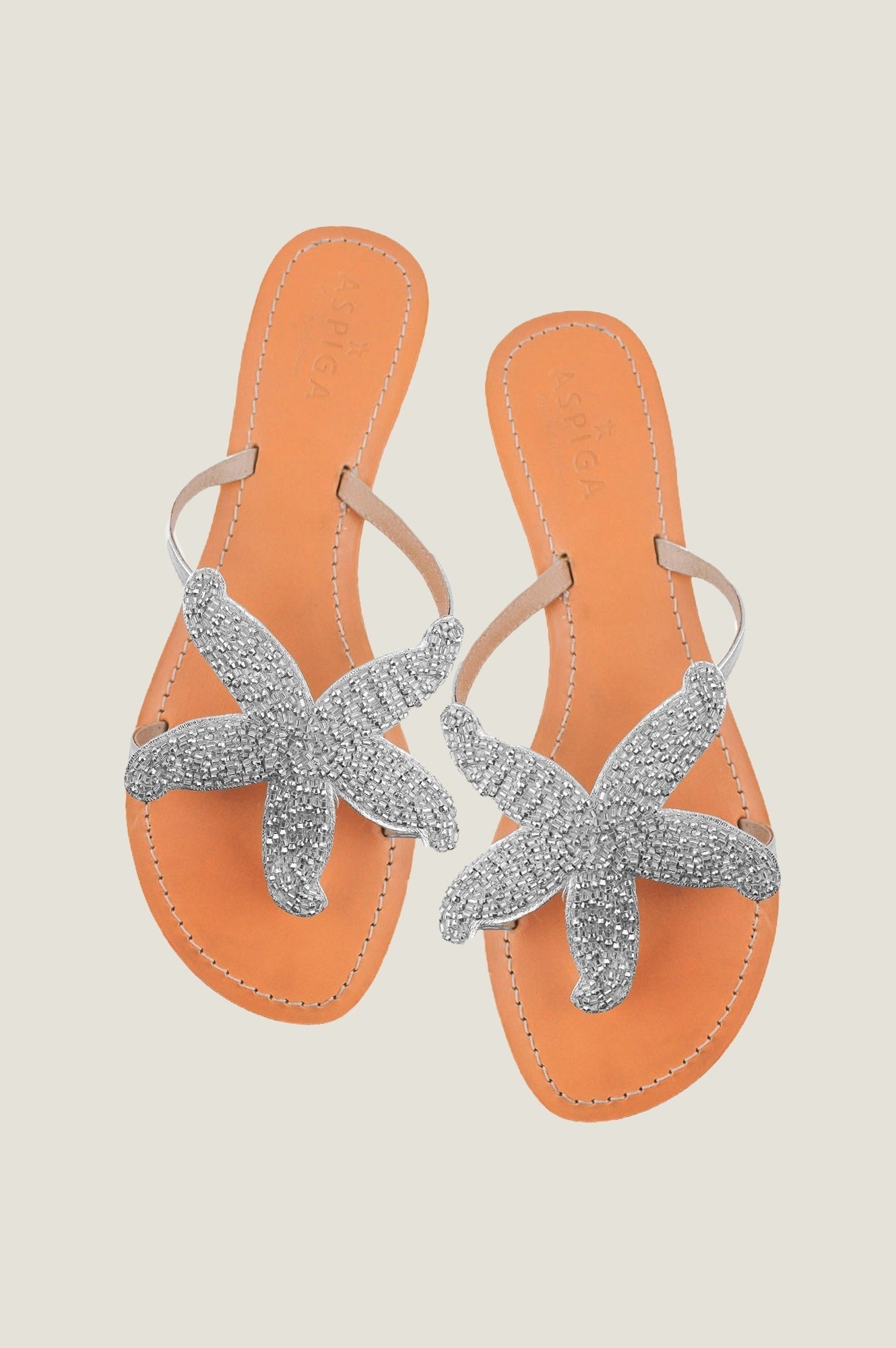 Silver beaded starfish sandals with toe post, slim straps, and flat sole.