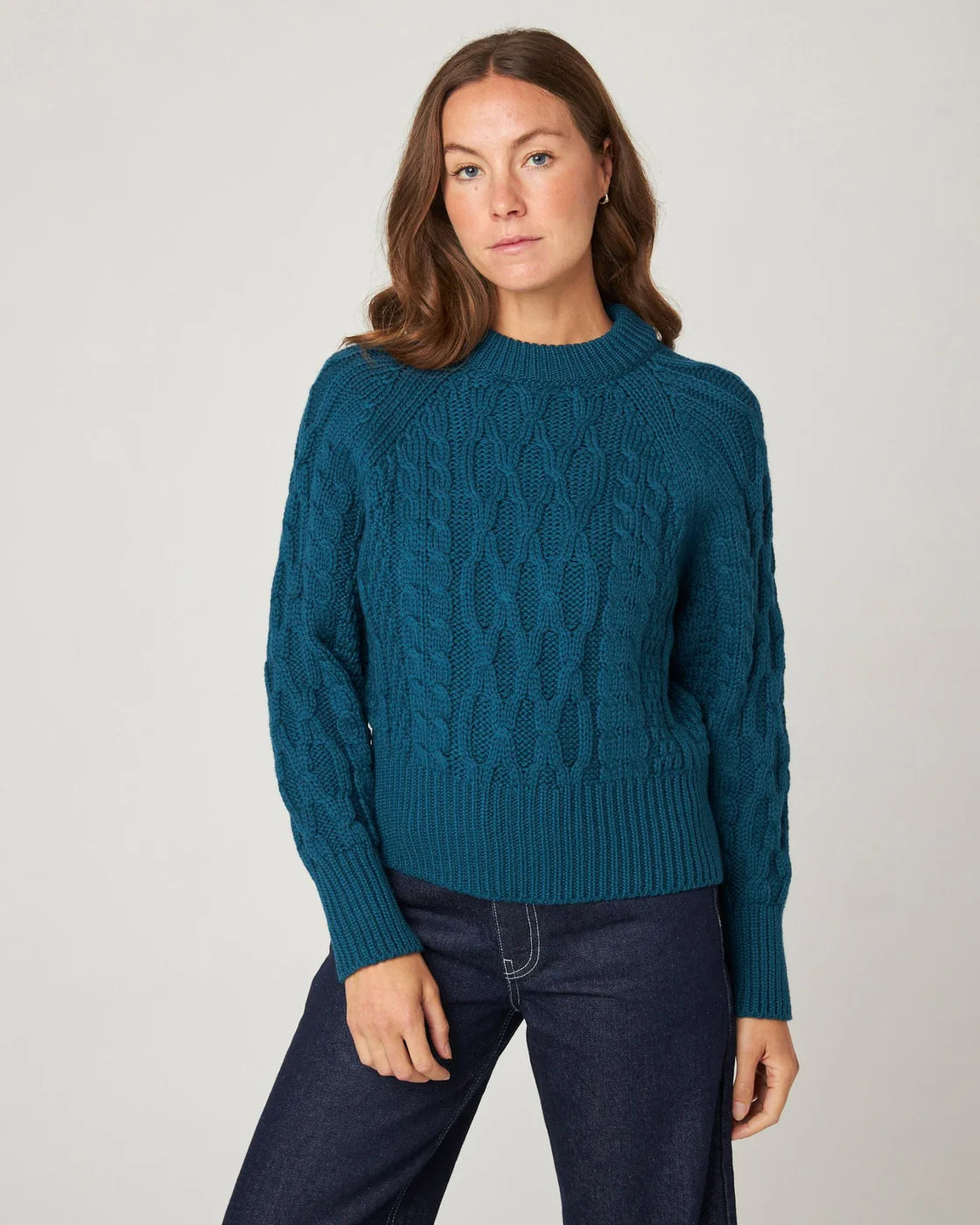 Model wears teal knitted merino sweater by Peregrine Clothing, filtered for the Cool Winter, Deep Winter, and Cool Summer colour seasons.