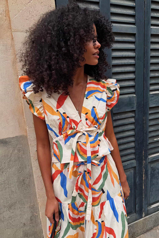 Banana print wrap blouse with puff sleeves.