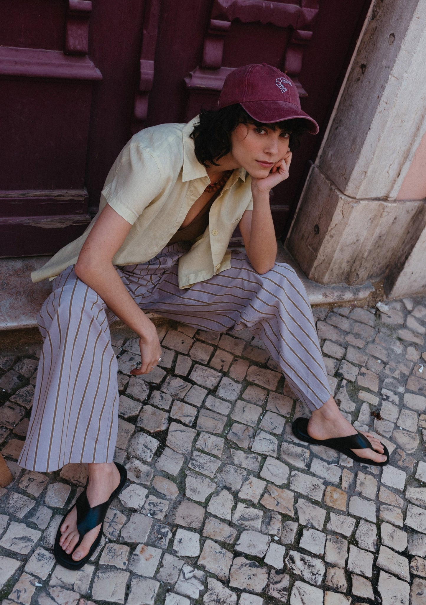 Grey striped trousers with lavender-grey base and fine vertical olive stripes, elasticated waistband, and relaxed straight-leg fit