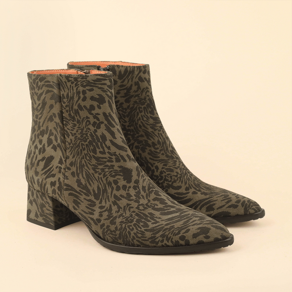 A pair of pointed-toe ankle boots with a dark brown and olive green animal print pattern, shown against a solid light beige background.