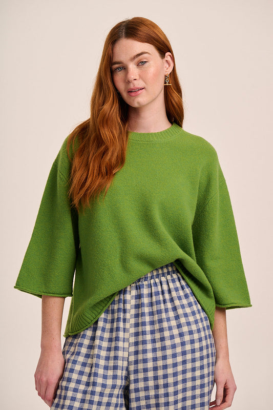 Bright green knitted top with round neckline, three-quarter length sleeves, and relaxed boxy silhouette.