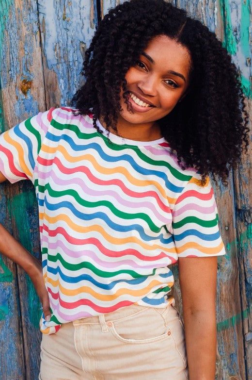 Organic cotton t-shirt with rainbow wave stripes.