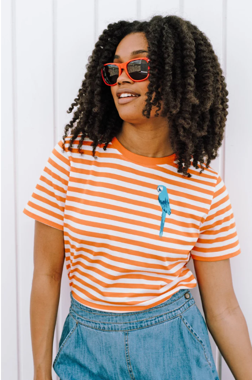 Orange and white striped short-sleeve T-shirt with small blue parrot motif on the chest