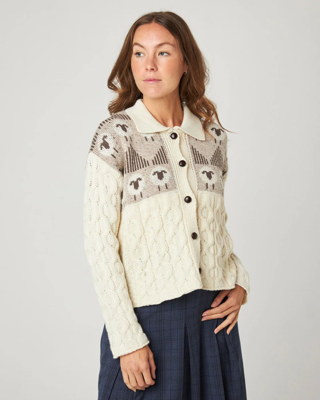 Model wears cream ecru cable knitted cardigan with sheep pattern, by Peregrine Clothing, filtered for the Soft Autumn and Light Spring colour seasons.