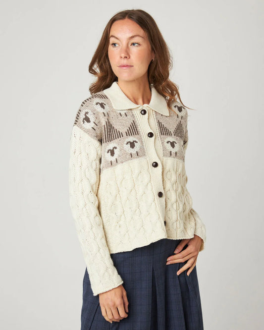 Model wears cream ecru cable knitted cardigan with sheep pattern, by Peregrine Clothing, filtered for the Soft Autumn and Light Spring colour seasons.