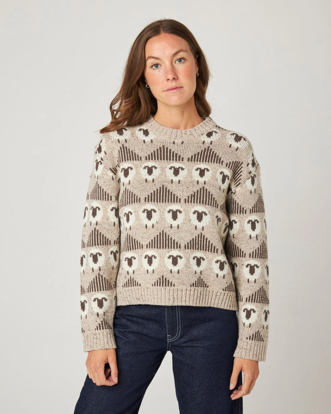 Model wearing ecru merino wool jumper with sheep pattern, by Peregrine Clothing, filtered for the Soft Autumn colour season.