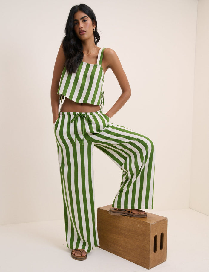 Green and white wide stripe wide leg linen trousers.