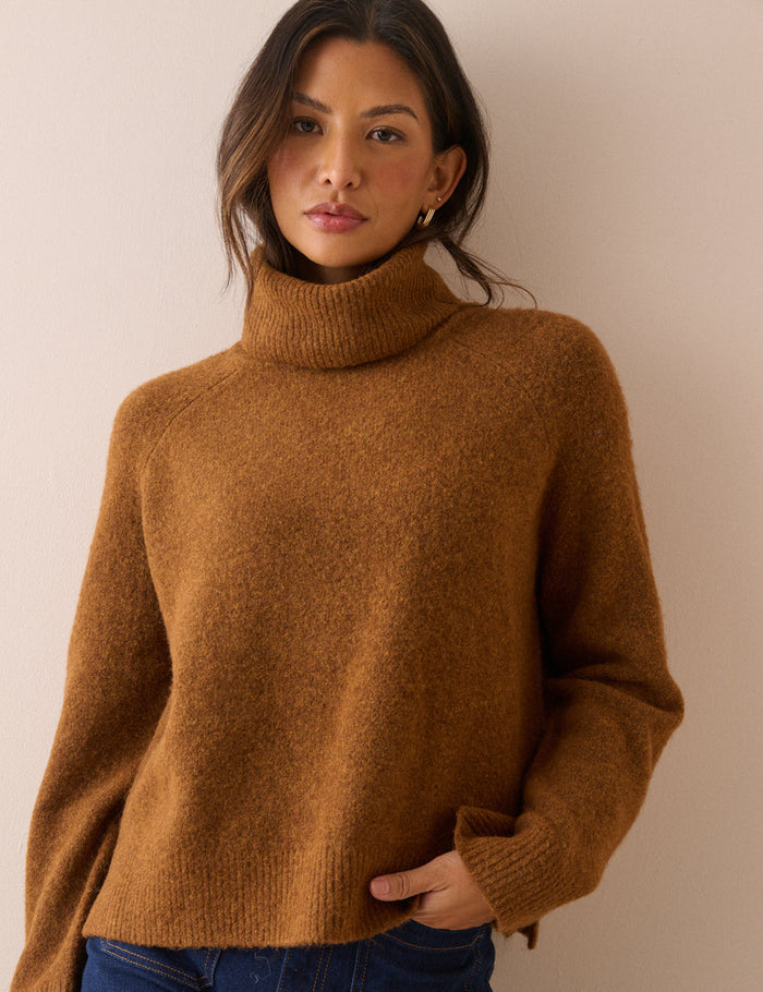 Rust oversized roll neck jumper.