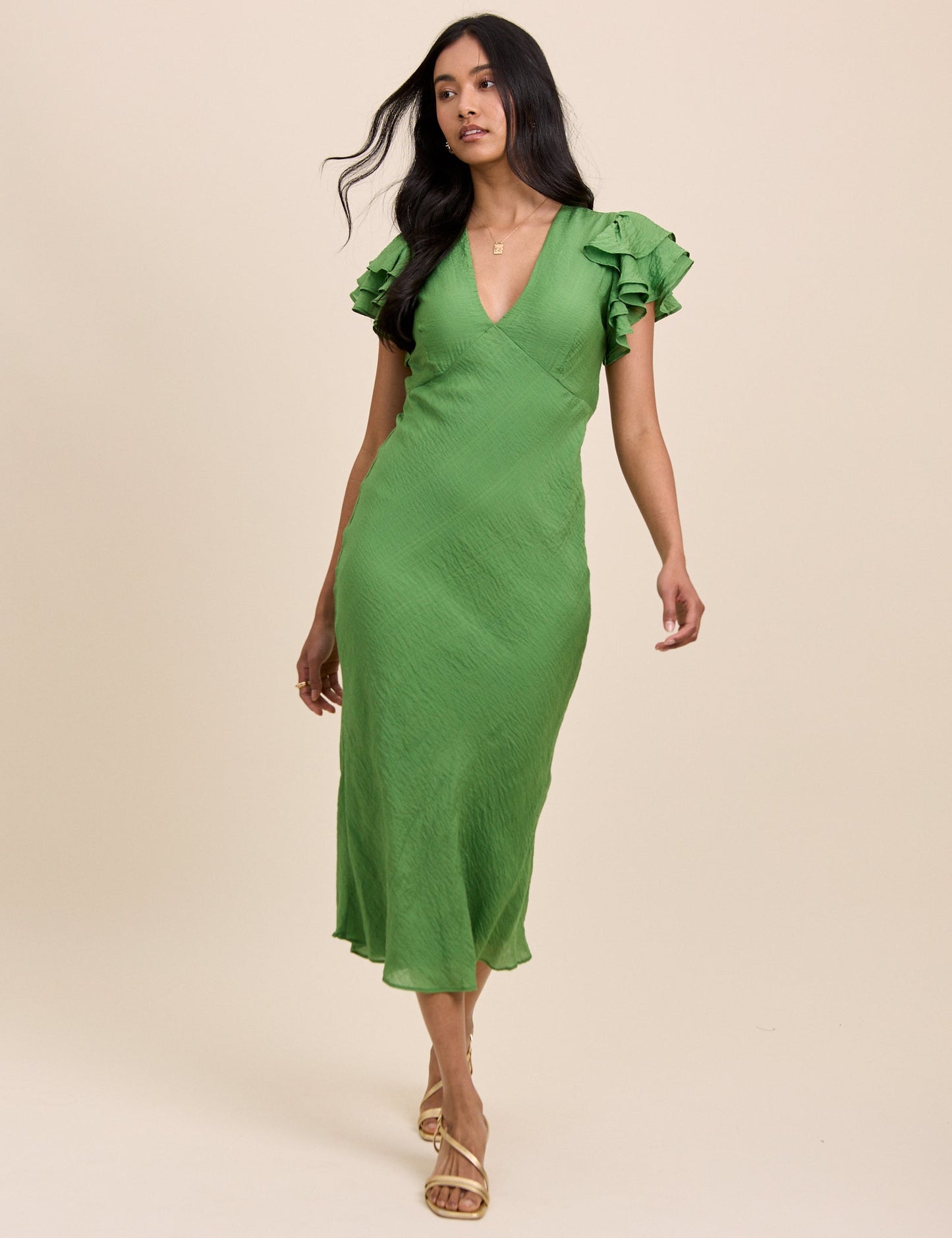 Grass green v-neck midi dress with ruffle sleeves.