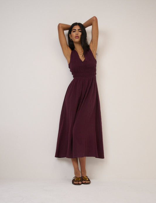 Deep plum shirred sleeveless midi dress.