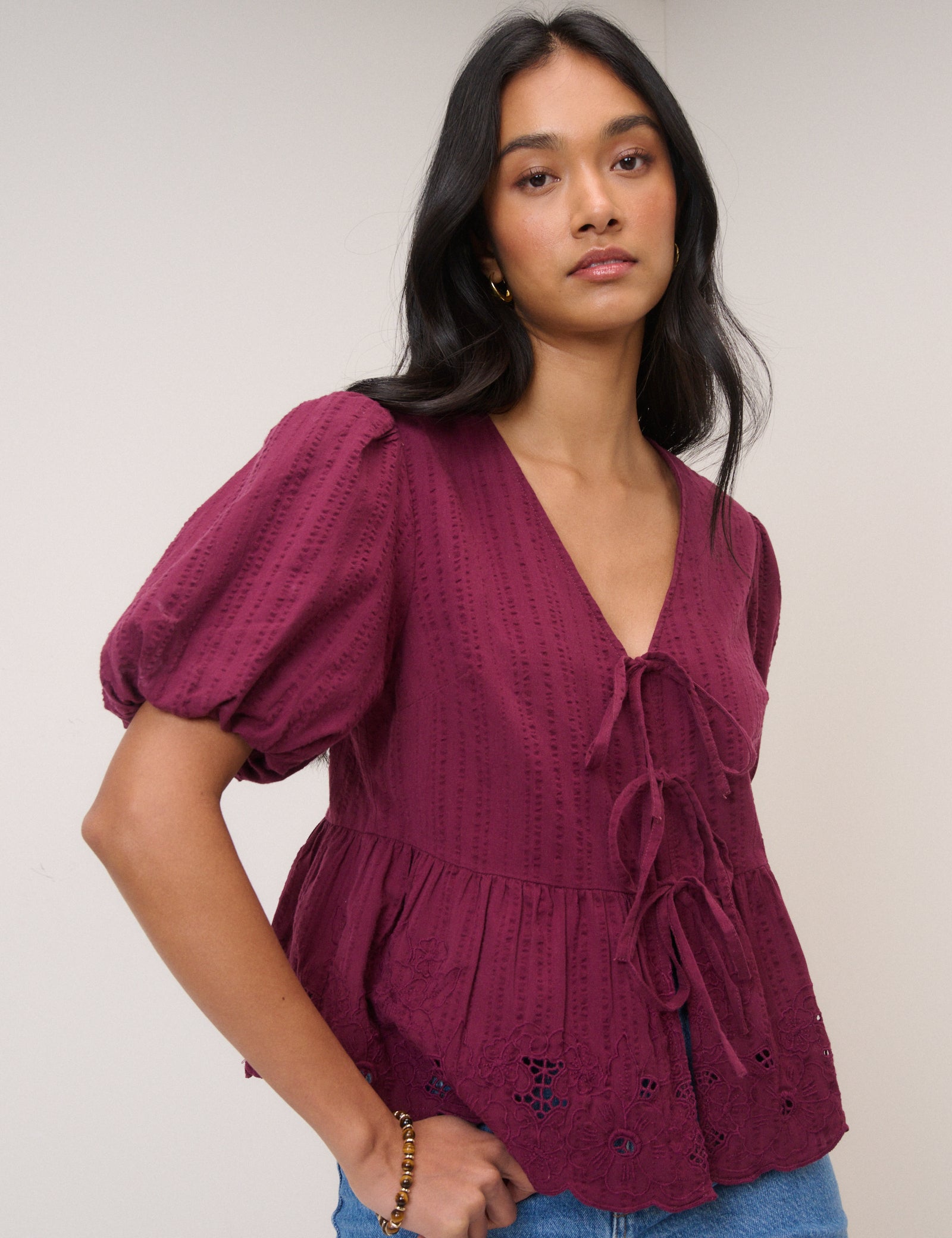 Deep berry broderie blouse with puff sleeves and tie front.