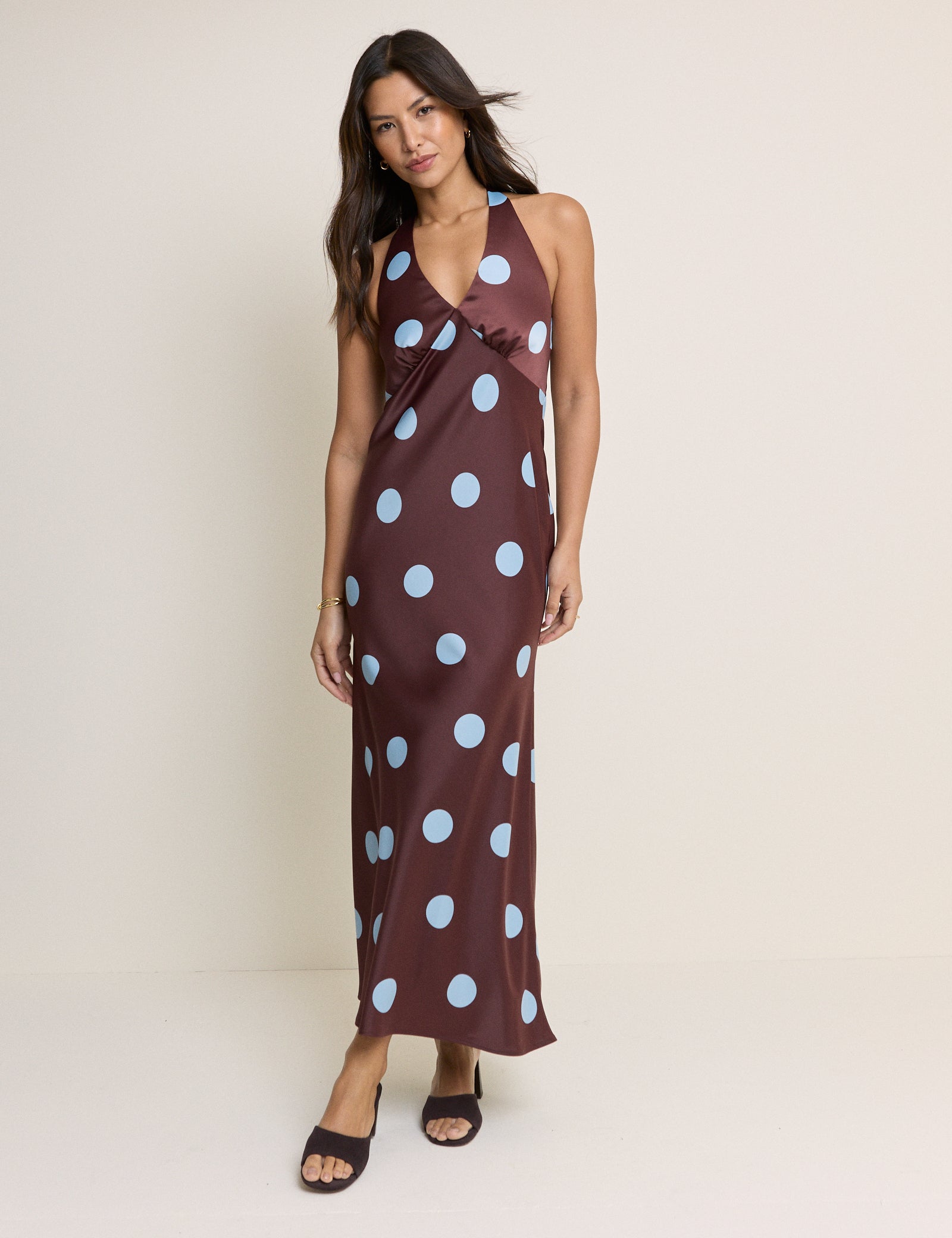 Brown satin halterneck dress with blue polka dots.