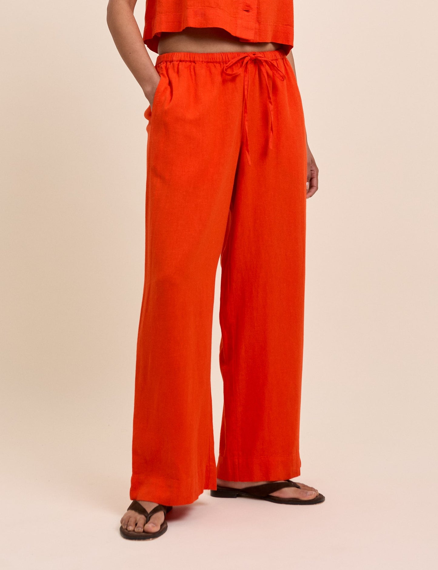 Bright red-orange linen trousers.