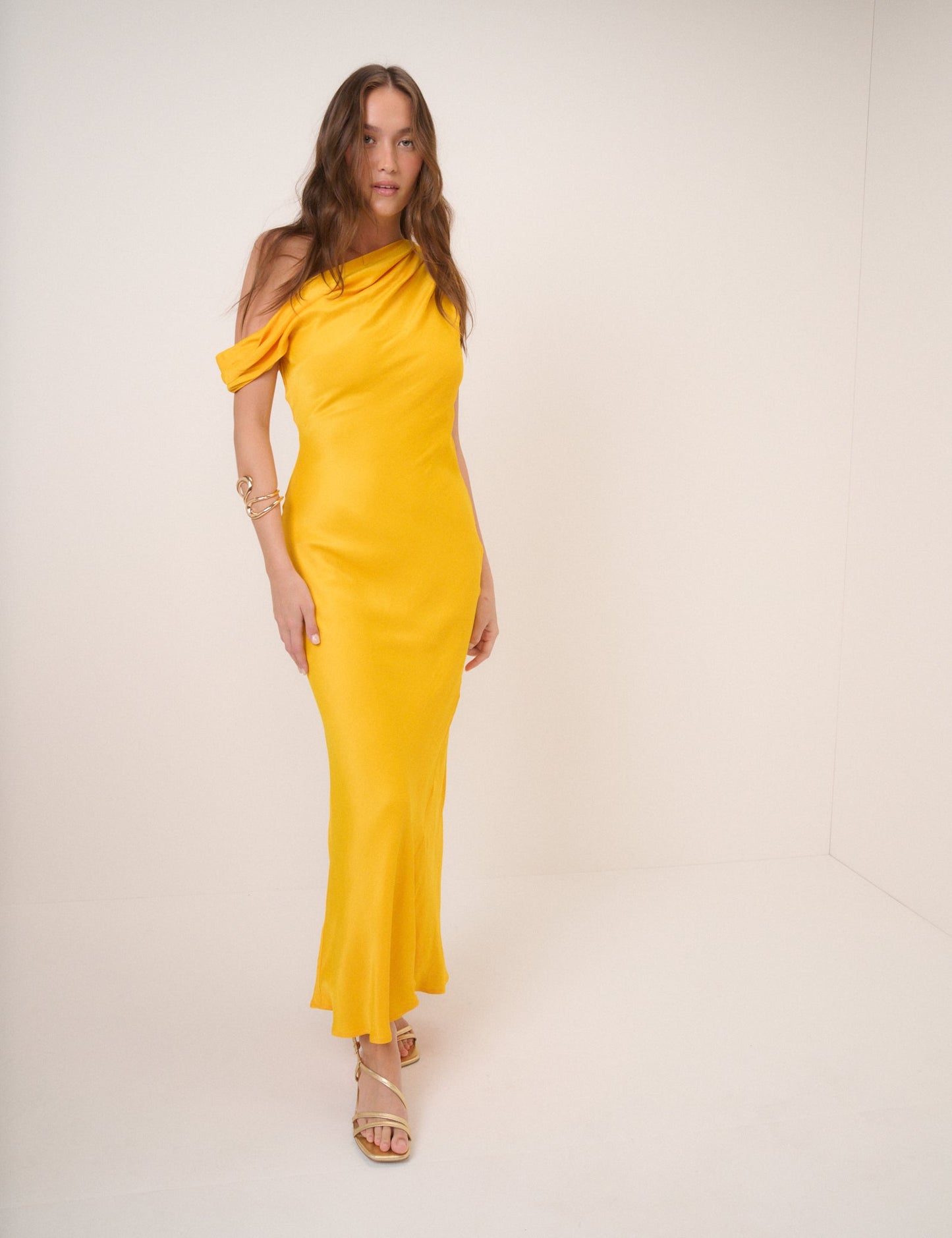 Bright yellow one shoulder maxi dress.