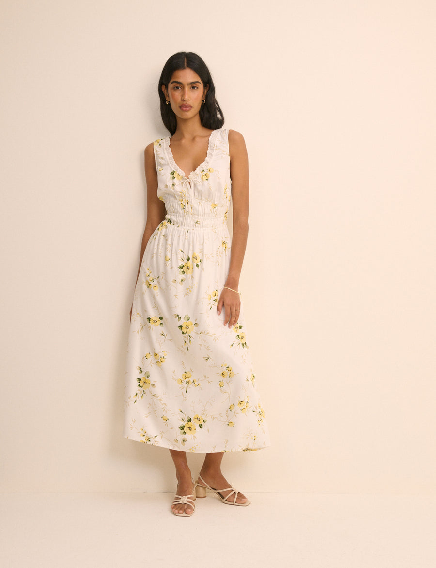White lace trim dress with yellow flowers.