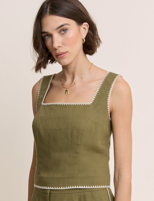 Olive green tailored top with stitched edges.
