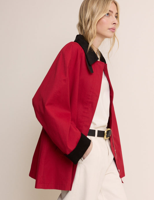 Red cord barn jacket with black collar and cuff details.